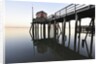 Fishing pier at low tide in a calm bay by Anonymous