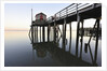 Fishing pier at low tide in a calm bay by Anonymous