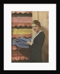 Woman puting away blanket in linen closet by Anonymous