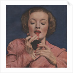 Woman putting on lipstick by Anonymous