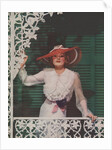 Woman with picture hat on front porch by Anonymous