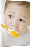 Boy having ice cream with spoon by Anonymous