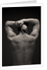 Rear view of a male stretching his arm behind his head by Anonymous