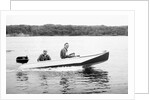 Two brothers speed by in a motor boat on a Wisconsin lake, ca. 1956 by Anonymous