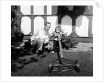 A father show his two year old daughter how to mow the lawn, ca. 1956 by Anonymous