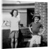 Brother and sister playing in front of their house, ca. 1965 by Anonymous