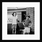 Brother and sister playing in front of their house, ca. 1965 by Anonymous