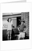 Brother and sister playing in front of their house, ca. 1965 by Anonymous