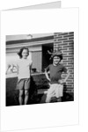 Brother and sister playing in front of their house, ca. 1965 by Anonymous