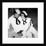 A sailor poses with his"sailor" girlfriend at a party, ca. 1955 by Anonymous