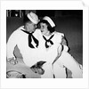 A sailor poses with his"sailor" girlfriend at a party, ca. 1955 by Anonymous