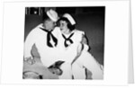 A sailor poses with his"sailor" girlfriend at a party, ca. 1955 by Anonymous