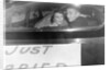 A couple peers out of the back window on their wedding day, ca. 1953 by Anonymous