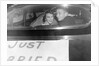 A couple peers out of the back window on their wedding day, ca. 1953 by Anonymous
