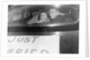 A couple peers out of the back window on their wedding day, ca. 1953 by Anonymous