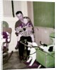 A father reads to his 4 year old daughter, ca. 1957 by Anonymous