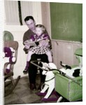 A father reads to his 4 year old daughter, ca. 1957 by Anonymous