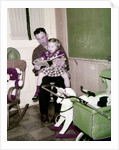 A father reads to his 4 year old daughter, ca. 1957 by Anonymous