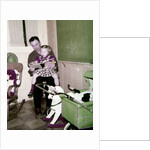 A father reads to his 4 year old daughter, ca. 1957 by Anonymous