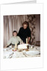 Nine year old girl is about to blow out the candles on her while her mom watches, ca. 1962 by Anonymous
