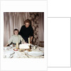 Nine year old girl is about to blow out the candles on her while her mom watches, ca. 1962 by Anonymous