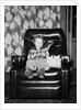 Young girl sits with her two cats in a leather chair, ca. 1960 by Anonymous