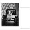 Young girl sits with her two cats in a leather chair, ca. 1960 by Anonymous