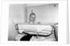 One year old baby girl enjoys her bath, ca. 1953 by Anonymous