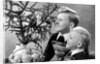 Two brothers look at a candle on a Christmas tree in Germany, ca. 1950 by Anonymous
