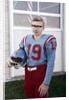 Fifteen year old high school football player portrait outside the school, ca. 1961 by Anonymous