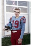 Fifteen year old high school football player portrait outside the school, ca. 1961 by Anonymous