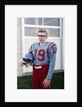 Fifteen year old high school football player portrait outside the school, ca. 1961 by Anonymous