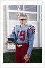 Fifteen year old high school football player portrait outside the school, ca. 1961 by Anonymous