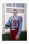 Fifteen year old high school football player portrait outside the school, ca. 1961 by Anonymous