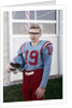 Fifteen year old high school football player portrait outside the school, ca. 1961 by Anonymous