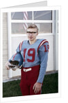 Fifteen year old high school football player portrait outside the school, ca. 1961 by Anonymous