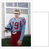 Fifteen year old high school football player portrait outside the school, ca. 1961 by Anonymous