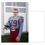 Fifteen year old high school football player portrait outside the school, ca. 1961 by Anonymous
