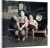 Two brothers sit on the bumper of the family Mercedes Benz in Germany, ca. 1949 by Anonymous