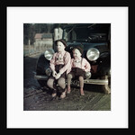 Two brothers sit on the bumper of the family Mercedes Benz in Germany, ca. 1949 by Anonymous
