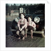 Two brothers sit on the bumper of the family Mercedes Benz in Germany, ca. 1949 by Anonymous