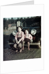 Two brothers sit on the bumper of the family Mercedes Benz in Germany, ca. 1949 by Anonymous