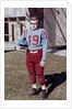 Fifteen year old high school football player portrait outside the school, ca. 1961 by Anonymous