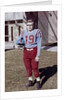 Fifteen year old high school football player portrait outside the school, ca. 1961 by Anonymous