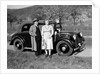 Father and mother stand with their son sitting on the hood of their Mercedes automobile, ca. 1950 by Anonymous