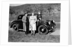 Father and mother stand with their son sitting on the hood of their Mercedes automobile, ca. 1950 by Anonymous