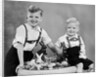 Two brothers sit with Easter decorations, ca. 1948 by Anonymous
