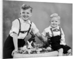 Two brothers sit with Easter decorations, ca. 1948 by Anonymous