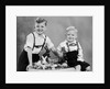 Two brothers sit with Easter decorations, ca. 1948 by Anonymous