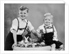 Two brothers sit with Easter decorations, ca. 1948 by Anonymous